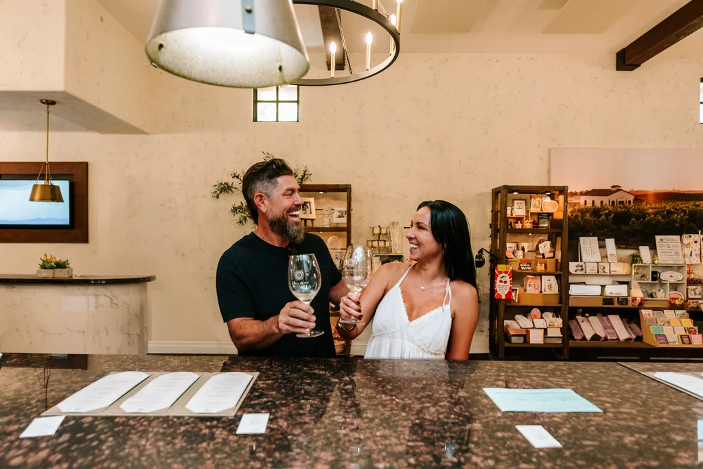 Couple enjoying a wine tasting experience at a Kentina Hospitality destination in Temecula Valley