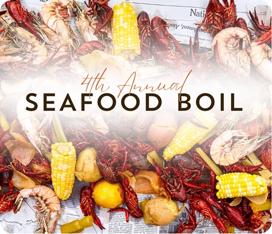 Promotional graphic for the 4th Annual Seafood Boil featuring crawfish, shrimp, corn, potatoes, and other seafood served family-style.