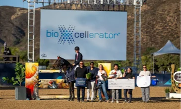 Participants celebrating an equestrian competition awards ceremony at a premier Temecula Valley horse show venue with riders, spectators, and event sponsors in attendance