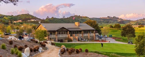 Scenic golf clubhouse overlooking a championship course in Temecula Valley with rolling hills, manicured greens, and panoramic countryside views