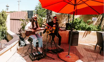Musicians performing live music on an outdoor winery patio in Temecula Wine Country, creating a relaxed hospitality and entertainment experience