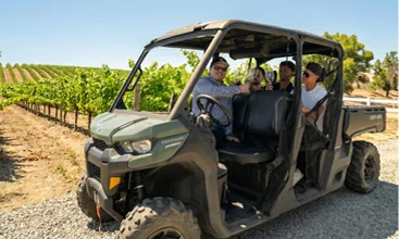 Guests exploring vineyard rows during a guided winery tour in Temecula Wine Country aboard an off-road utility vehicle