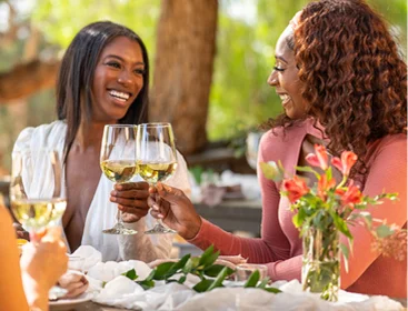 Guests enjoying wine and conversation during an outdoor dining experience in Temecula Wine Country